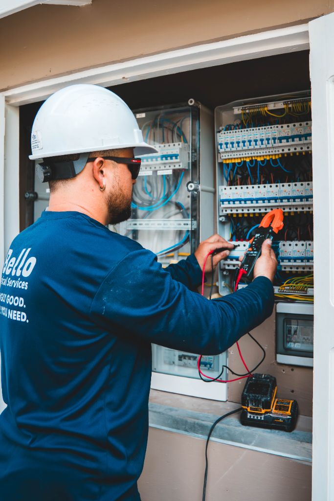 Bello Electrical Services technician inspecting panel
